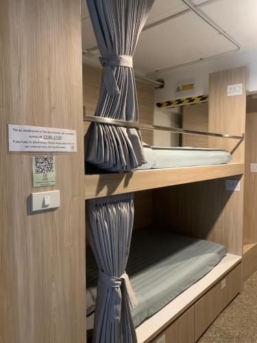 a couple of bunk beds in a room at Marni BKK Hostel in Bangkok