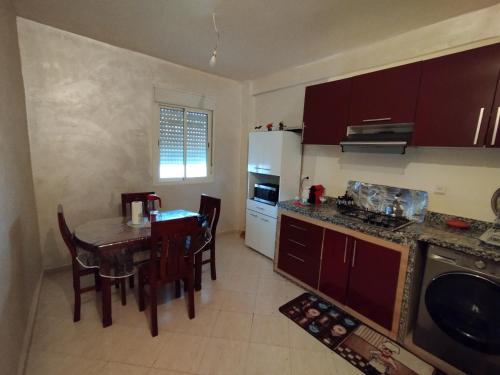 a kitchen with a table and a dining room at Magnifique appartement au RDC in Casablanca
