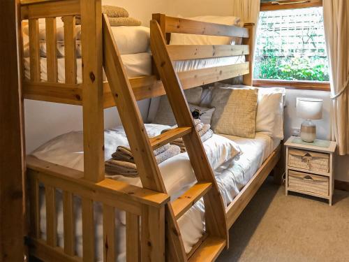a bunk bed in a room with a bunk bed in a house at The Lodge in Uny Lelant