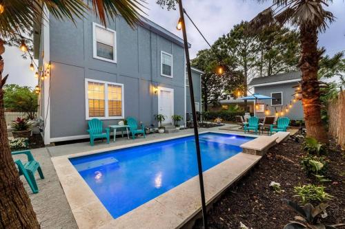 a swimming pool in front of a house at 5/3 with a heated pool 2 min from beach, updated in Galveston