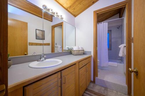a bathroom with a sink and a mirror and a shower at Snowbasin + Powder Mountain + Spa + Eden in Eden