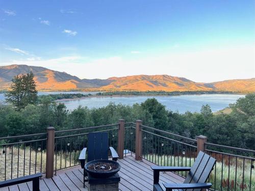 a deck with a view of a lake and mountains at Snowbasin + Powder Mountain + Spa + Eden in Eden