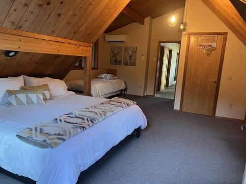 a bedroom with two beds and a wooden ceiling at Snowbasin + Powder Mountain + Spa + Eden in Eden