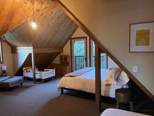 a attic bedroom with a bed and a staircase at Snowbasin + Powder Mountain + Spa + Eden in Eden