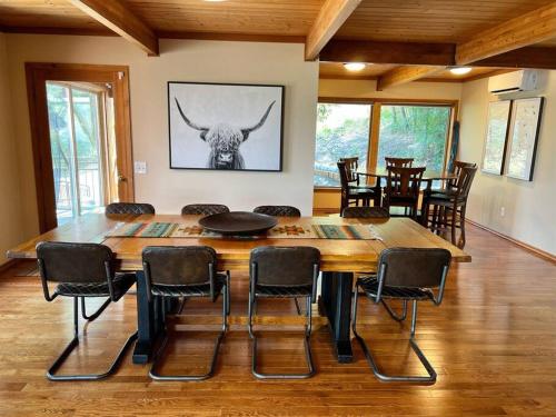a dining room with a large wooden table and chairs at Snowbasin + Powder Mountain + Spa + Eden in Eden