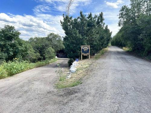 a dirt road with a sign in the middle at Snowbasin + Powder Mountain + Spa + Eden in Eden