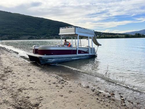 a boat on the shore of a body of water at Snowbasin + Powder Mountain + Spa + Eden in Eden
