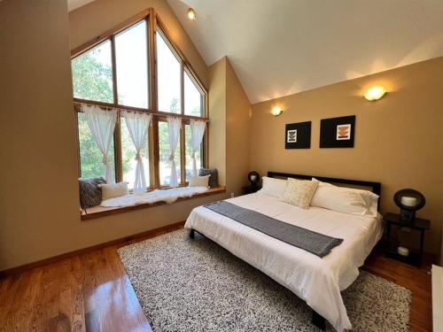 a bedroom with a large bed and a large window at Snowbasin + Powder Mountain + Spa + Eden in Eden