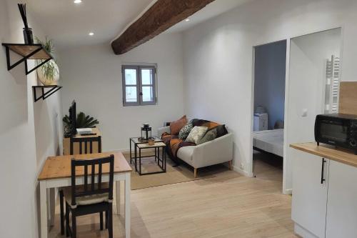 a living room with a couch and a bed at Charming studio in the historic centre in Montpellier