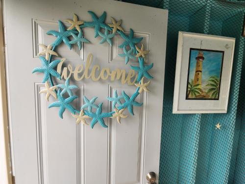 a door with a welcome sign and starfish on it at The Starlight Tower Manor, River, Arcades, Observatory, Theater in Fort Atkinson