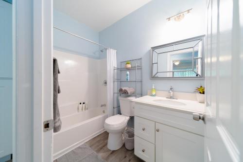 a white bathroom with a sink and a toilet at Cozy 1 BR in Historic SD Walk to Restaurants in San Diego