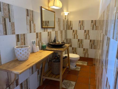 a bathroom with a sink and a toilet at Bình An Village in Vĩnh Long