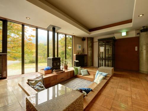 a living room with a couch and a fireplace at the Kinta Naeba in Yuzawa