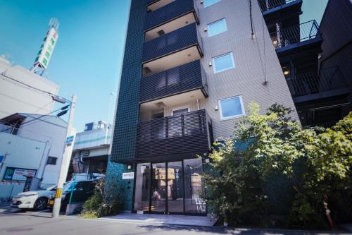 a tall building on a city street at WAYFARER Matsu in Osaka