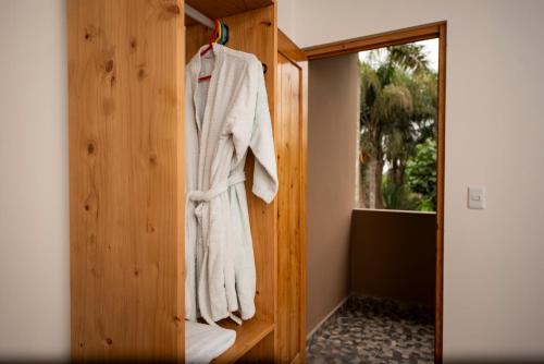 a robe hanging on a wooden wall in a room at Casa Boutique QX- Pachacamac in Pachacamac