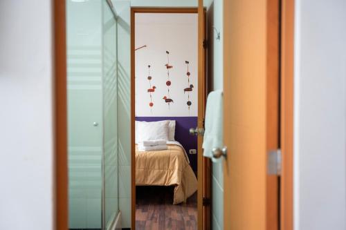 a door leading to a bedroom with a bed at Casa Boutique QX- Pachacamac in Pachacamac