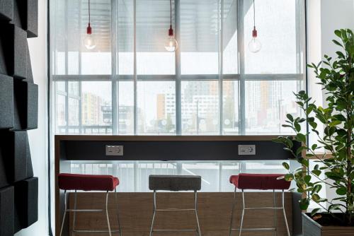 a room with two chairs and a large window at Holiday Inn Express - Astana - Turan by IHG in Astana