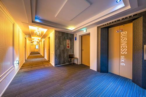 a corridor of a hotel with a hallway leading into a room at Gongju No 25 Hotel in Gongju