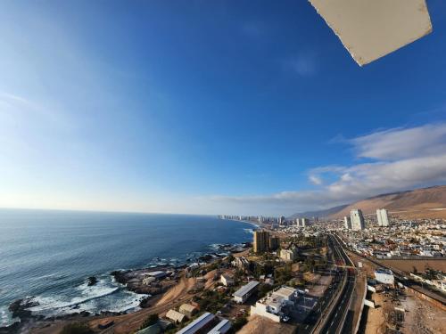 an aerial view of a city and the ocean at Playa Huayquique, primera linea in Iquique