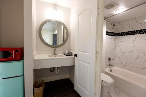 a bathroom with a sink and a mirror at CRYSTAL PALACE RESORT in Bolivar Peninsula