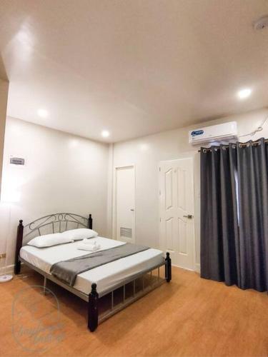 a bedroom with a bed with a black curtain at Private Guest House Bay Breeze in San Juan