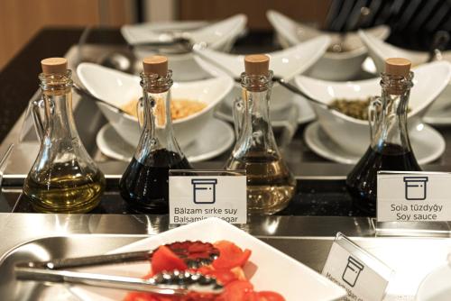 a table with bottles of wine and a plate of food at Holiday Inn Express - Astana - Turan by IHG in Astana