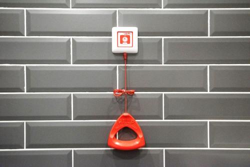 a pair of red scissors hanging from a white outlet at Holiday Inn Express - Astana - Turan by IHG in Astana