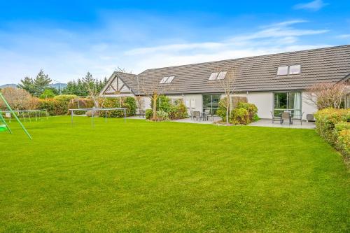 a house with a large lawn in front of it at Hanmer Apartments in Hanmer Springs