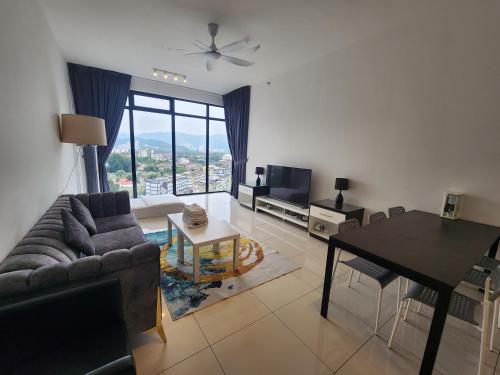 a living room with a couch and a table at Beacon Executive Suites in George Town