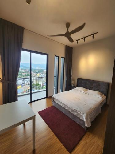 a bedroom with a bed and a ceiling fan at Beacon Executive Suites in George Town
