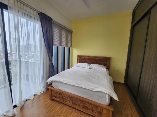 a bedroom with a bed and a large window at Beacon Executive Suites in George Town