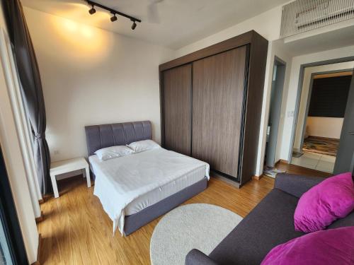 a small bedroom with a bed and a couch at Beacon Executive Suites in George Town