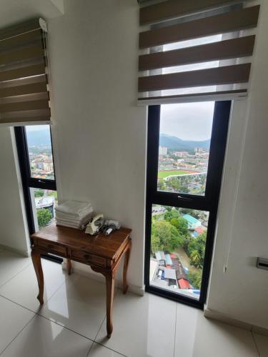 a room with a table and two large windows at Beacon Executive Suites in George Town