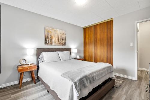 a bedroom with a large bed and a wooden door at Elm Park in Port Colborne