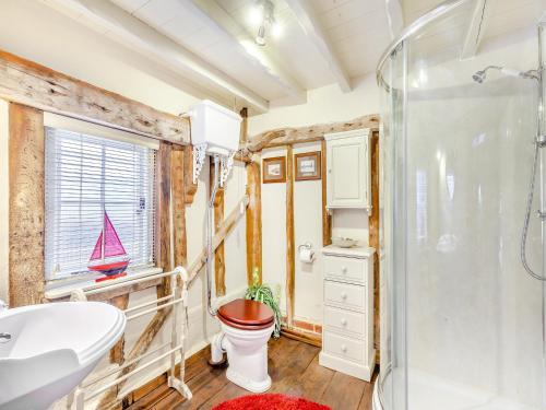 a bathroom with a shower and a toilet and a sink at Sail Loft-uk45571 in Maldon