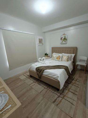 a bedroom with a large bed in a room at Minimalist Condo Studio at Messavire Garden Residence near Ruins Bacolod in Bacolod