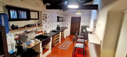 a kitchen with a counter and some chairs in it at xplorest in Mysore