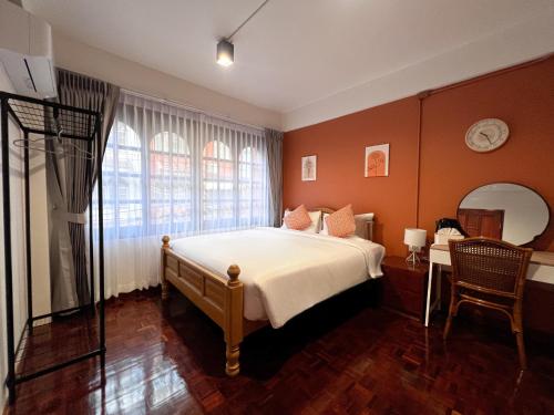 a bedroom with a bed and a mirror at SO One Silom Apartment in Bang Rak