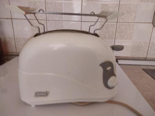 a white toaster sitting on top of a toilet at NASOS APARTMENT METEORA in Kalabaka