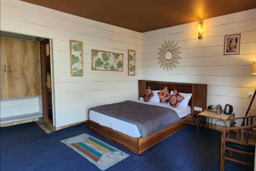 a bedroom with a large bed in a room at The Mystic Pines in Nainital