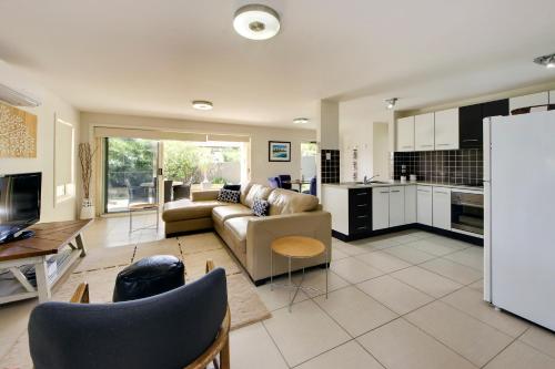 a large living room with a couch and a kitchen at Geckos at South West Rocks - 29 Marlin Drive in South West Rocks