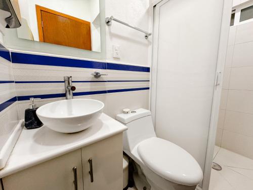 a bathroom with a sink and a toilet and a mirror at Beautiful Apartment, Airport, Downtown, Foro Sol in Mexico City