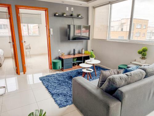 a living room with a couch and a tv at Beautiful Apartment, Airport, Downtown, Foro Sol in Mexico City