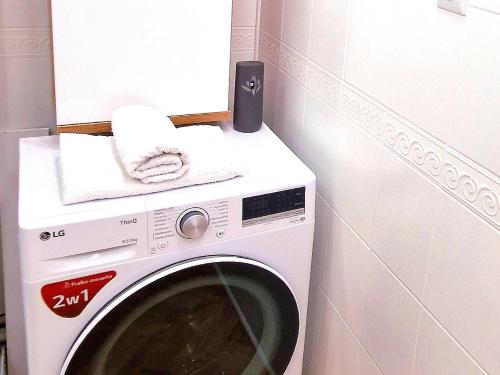 a washing machine with a towel on top of it at Honey Aquapark View in Płock