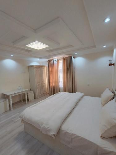 a bedroom with a large white bed in a room at Dari Zanjir in Samarkand