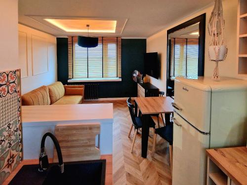 a kitchen and living room with a refrigerator and a table at Honey Aquapark View in Płock