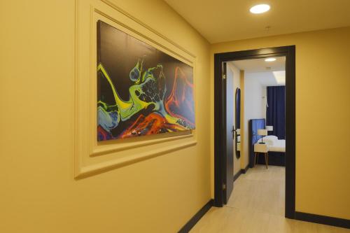 a hallway with a painting hanging on a wall at Ravello Suites Taksim in Istanbul