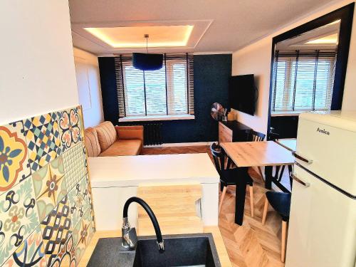 a kitchen with a sink and a refrigerator in a room at Honey Aquapark View in Płock