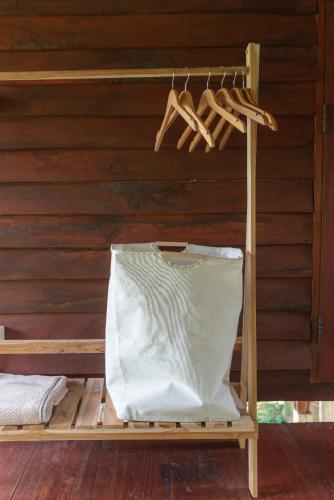 a bed in a room with a wooden wall at Paddy Fields Haven - Natures Nest in Pai