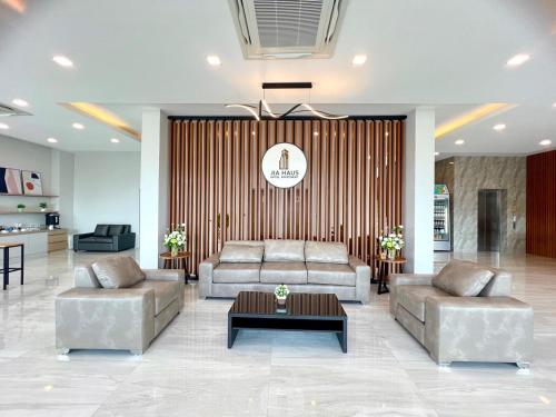 a living room with two couches and a table at JIA HAUS Hotel Apartment in Buriram
